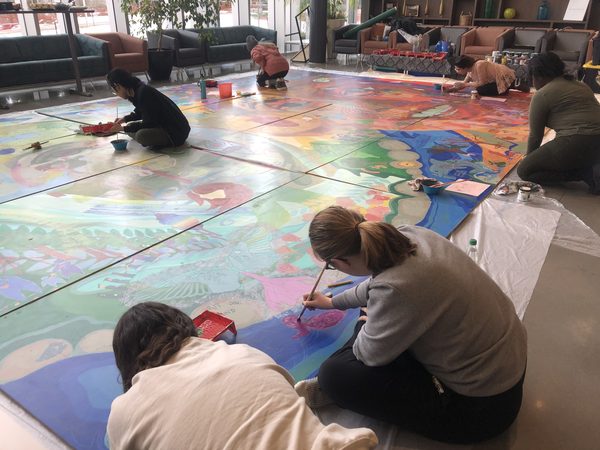Community engagement. Painting on the floor, Brescia Centennial Portraiture